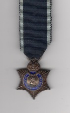 Obverse view of medal. Indian Title Badge George V issue, 3rd class, 'Sardar Sahib' for Hindus, silver gilt and enamel.