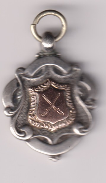 Watch Fob, 5th Cheshire Regiment, John Hall Cup 1912 won by Private Whipp, obverse crossed rifles 9ct shield center.    VF