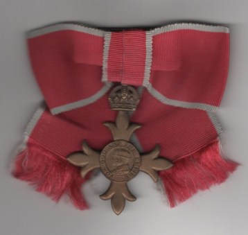 Obverse view of Most Excellent Order of the British Empire, Officers O.B.E., 2nd type (civil) ladies issue on a bow G.V.I.
