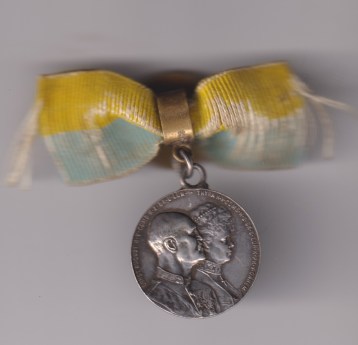 Silver Medal dated 1903, commemorating the Silver Wedding Anniversary of H.R.H. Ernest Augustus, 3rd Duke of Cumberland, and H.R.H. Princess Thyra, on lapel bow.  VF