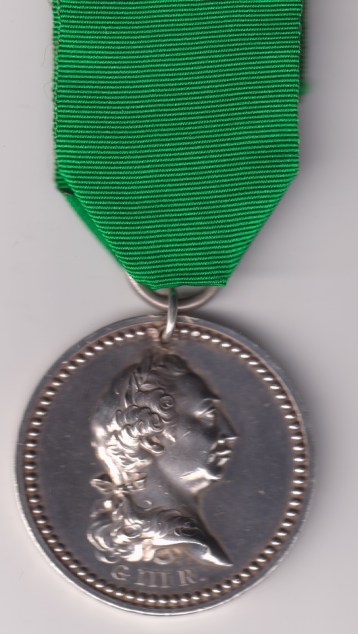 Best shot the 3rd Company, 31st July, 1805.’, with pierced loop silver suspension ring, hallmarked silver. A large circular engraved medal, 48mm, silver, obverse with a laurelated head of George III, with an embossed ‘GIIIR’ below, reverse with an embossed wreath of oak, a drum before a Union flag and a City of London flag, with engraving above ‘From Sir Robert Wigram, Bart., M.P., Lieut.-Col.-Commandant, Adjudged to James Summersett’, the edge engraved ‘Best shot of the 3rd Company, 31st July, 1805. VF/GVF