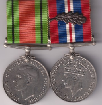 Defence Medal, War Medal, with M.I.D. oakleaf, mounted on a pin as worn.